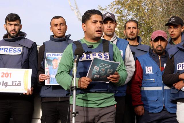 Members of the press stand in solidarity after an Israeli missile hit a media broadcast truck in Nuseirat, on December 26, 2024, outside the Baptist Hospital in Gaza City, amid the ongoing war between Israel and the Palestinian Hamas movement. Palestinian TV channel affiliated with a militant group said five of its journalists were killed on December 26, in an Israeli strike on their vehicle in Gaza, with Israel's military saying it had targeted a "terrorist cell". (Photo by Omar AL-QATTAA / AFP)