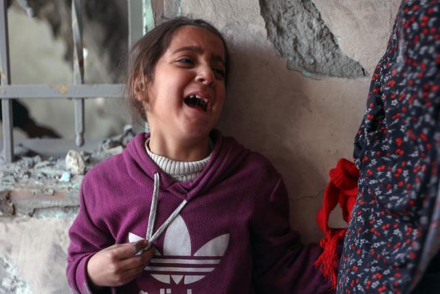 A child cries at the site of an Israeli strike in a residential area in the Tuffah neighbourhood, east of Gaza City, on December 26, 2024, amid the ongoing war between Israel and the Palestinian Hamas movement. The health ministry in Hamas-run Gaza said on December 26, that 38 people had been killed in the Palestinian territory in the past 24 hours, taking the overall war death toll to 45,399. (Photo by Omar AL-QATTAA / AFP)