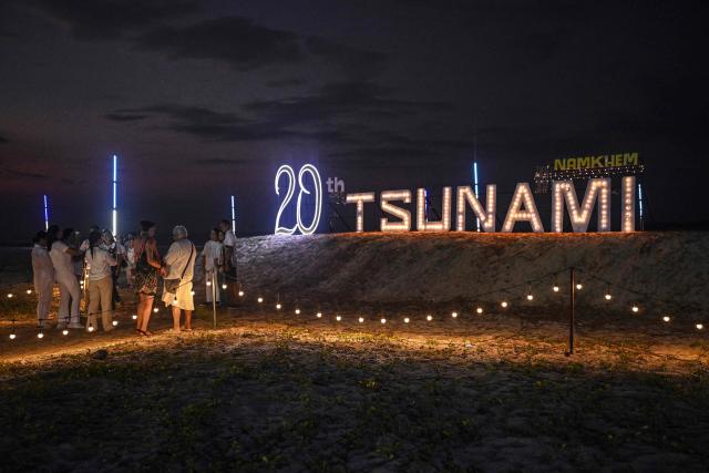 People gather on the beach at the Ban Nam Khem Tsunami Memorial Park in the southern Thai province of Phang Nga on December 26, 2024. Emotional ceremonies began across Asia on December 26 to remember the 220,000 people who died two decades ago when a tsunami devastated coastal areas around the Indian Ocean, in one of the worst natural disasters in human history. (Photo by Lillian SUWANRUMPHA / AFP)