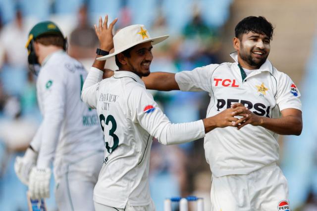 Pakistan's Khurram Shahzad (R) celebrates after the dismissal of South Africa's Ryan Rickelton (L) during the first day of the first cricket Test match between South Africa and Pakistan at SuperSport Park in Centurion on December 26, 2024. (Photo by PHILL MAGAKOE / AFP)