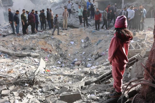 Civilians check the site of an Israeli strike in a residential area in the Tuffah neighbourhood, east of Gaza City, on December 26, 2024, amid the ongoing war between Israel and the Palestinian Hamas movement. The health ministry in Hamas-run Gaza said on December 26, that 38 people had been killed in the Palestinian territory in the past 24 hours, taking the overall war death toll to 45,399. (Photo by Omar AL-QATTAA / AFP)