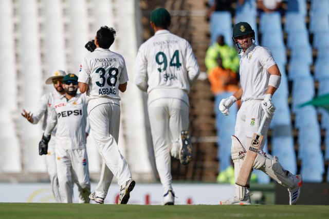 South Africa's Tristan Stubbs (R) walks back to the pavilion after his dismissal by Pakistan's Mohammad Abbas (3rd R) during the first day of the first cricket Test match between South Africa and Pakistan at SuperSport Park in Centurion on December 26, 2024. (Photo by PHILL MAGAKOE / AFP)