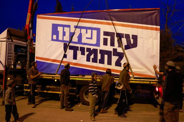 Israeli right-wing activists load a mobile house bearing a slogan which reads in Hebrew "Our Gaza Forever", onto a truck in the southern town of Sderot near the border with Gaza on December 26, 2024, for what they say is establishing a new Jewish settlement in the Gaza Strip, during an activity to promote the idea of settlement in the besieged Palestinian territory amid the ongoing war between Israel and the Palestinian Hamas movement. (Photo by Menahem KAHANA / AFP)