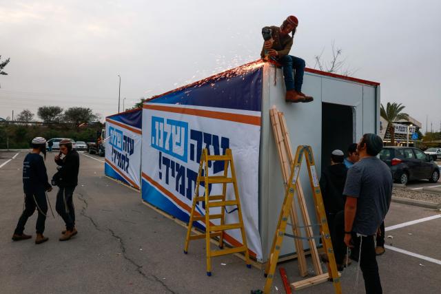 Israeli right-wing activists work on a mobile house bearing a slogan which reads in Hebrew "Our Gaza Forever", in the southern town of Sderot near the border with Gaza on December 26, 2024, for what they say is establishing a new Jewish settlement in the Gaza Strip, during an activity to promote the idea of settlement in the besieged Palestinian territory amid the ongoing war between Israel and the Palestinian Hamas movement. (Photo by Menahem KAHANA / AFP)