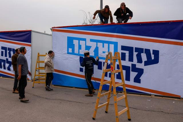 Israeli right-wing activists work on a mobile house bearing a slogan which reads in Hebrew "Our Gaza Forever", in the southern town of Sderot near the border with Gaza on December 26, 2024, for what they say is establishing a new Jewish settlement in the Gaza Strip, during an activity to promote the idea of settlement in the besieged Palestinian territory amid the ongoing war between Israel and the Palestinian Hamas movement. (Photo by Menahem KAHANA / AFP)