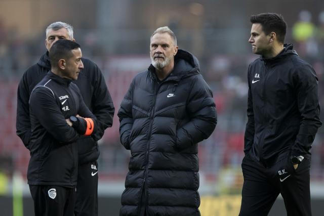 (From L ) Genk's Belgian individual coach Michel Ribeiro,Genk's German head coach Thorsten Fink and Genk's Croatian physical coach Goran Kontic speak at the end of the Belgian "Pro League" First Division football match between Royal Antwerp FC and KRC Genk at the Bosuilstadion, in Antwerp on December 26, 2024. (Photo by KRISTOF VAN ACCOM / BELGA / AFP) / Belgium OUT