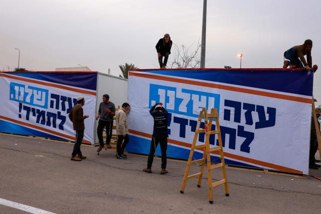 Israeli right-wing activists work on a mobile house bearing a slogan which reads in Hebrew "Our Gaza Forever", in the southern town of Sderot near the border with Gaza on December 26, 2024, for what they say is establishing a new Jewish settlement in the Gaza Strip, during an activity to promote the idea of settlement in the besieged Palestinian territory amid the ongoing war between Israel and the Palestinian Hamas movement. (Photo by Menahem KAHANA / AFP)