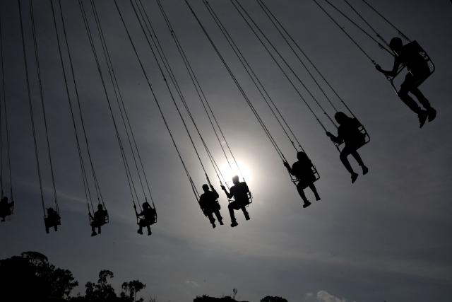 People ride on a Boxing Day Merry-go-round ride in Nairobi, Kenya, on December 26, 2024. (Photo by SIMON MAINA / AFP)