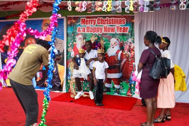 People pose for a holiday photo on Boxing Day in Nairobi, on December 26, 2024. (Photo by SIMON MAINA / AFP)