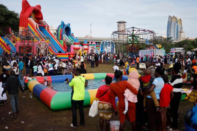 People visit a fairground near Uhuru Park on Boxing Day, in Nairobi, on December 26, 2024. (Photo by SIMON MAINA / AFP)