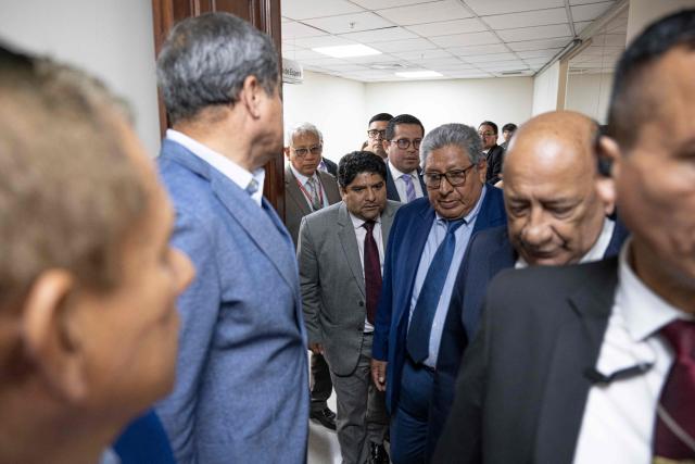 Lawyer Jorge Torres (C), former head of the Legal and Constitutional Office of the Peruvian Congress, arrives for a hearing at the Congress in Lima on December 26, 2024. Peru's Congress summoned to testify on Thursday a former official suspected of having set up an alleged prostitution ring in the legislature, according to a newspaper report.  (Photo by Ernesto BENAVIDES / AFP)