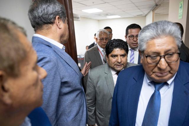 Lawyer Jorge Torres (2nd R), former head of the Legal and Constitutional Office of the Peruvian Congress, arrives for a hearing at the Carlos Torres y Torres Lara room, belonging to Congress, in Lima on December 26, 2024. Peru's Congress summoned to testify on Thursday former official and lawyer Jorge Torres, suspected of having set up an alleged prostitution ring in the legislature, according to a newspaper report. (Photo by Ernesto BENAVIDES / AFP)