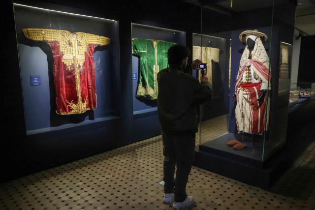 A visitor takes a picture of a traditional woman's dress at National Jewellery Museum, a part of UNESCO's World Heritage sites, together with the medieval Kasbah of the Udayas, in Morocco's capital Rabat, on December 26, 2024. (Photo by AFP)