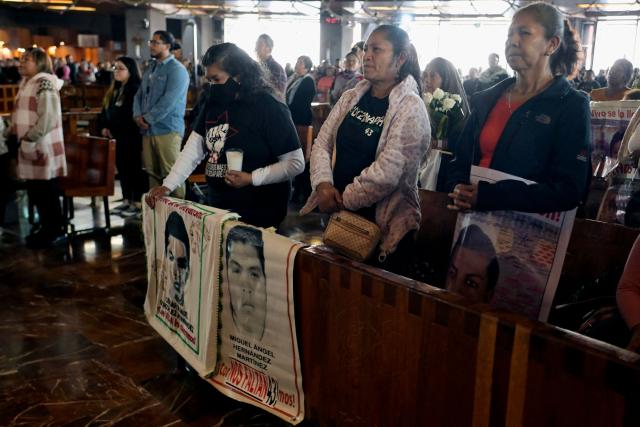 Relatives of the Ayotzinapa victims take part in a mass inside the Basilica of Our Lady of Guadalupe during a pilgrimage to demand justice in the case of the Ayotzinapa missing students in Mexico City on December 26, 2024. 26 September marked 10 years since the enforced disappearance of 43 students from the Ayotzinapa Rural Normal School. (Photo by ALFREDO ESTRELLA / AFP)