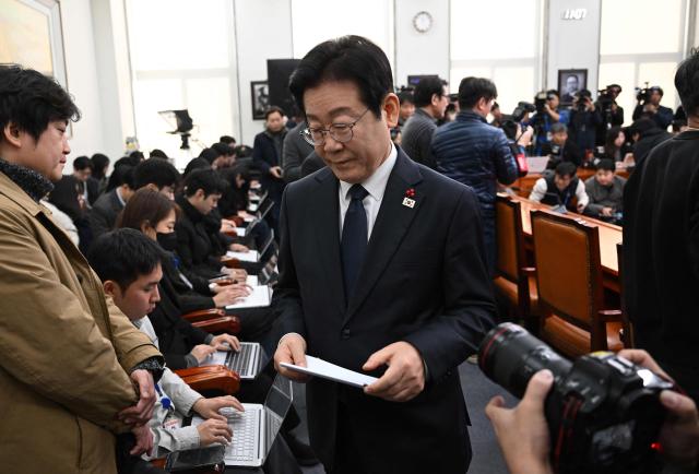 South Korea's main opposition Democratic Party leader Lee Jae-myung leaves after delivering a public statement on the impeachment motion against acting president Han Duck-soo at the National Assembly in Seoul on December 27, 2024. South Korea's acting president Han faced an impeachment vote on December 27, as the country struggled to shake off political turmoil sparked by his predecessor's martial law declaration that shocked the world. (Photo by JUNG YEON-JE / AFP)