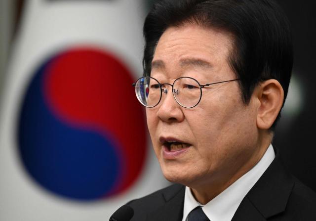 South Korea's main opposition Democratic Party leader Lee Jae-myung delivers a public statement on the impeachment motion against acting president Han Duck-soo at the National Assembly in Seoul on December 27, 2024. South Korea's acting president Han faced an impeachment vote on December 27, as the country struggled to shake off political turmoil sparked by his predecessor's martial law declaration that shocked the world. (Photo by JUNG YEON-JE / AFP)