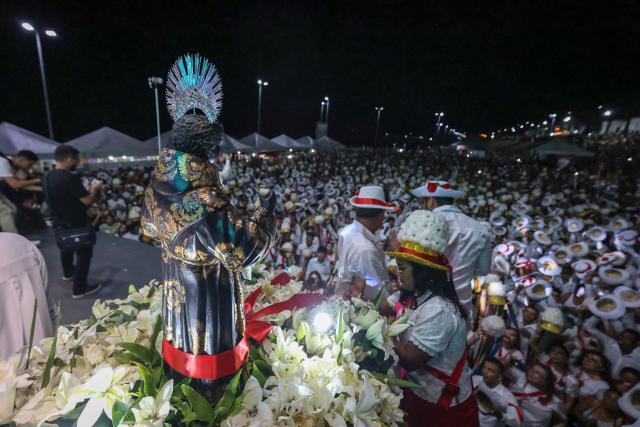 An image of the Saint Benedict is seen as people participate in the cultural and religious celebration Marujada, a traditional festival that pays homage to Saint Benedict (Sao Benedito) in the city of Bragança, Para State, Brazil, on December 26, 2024. Cultural heritage of Brazil, the Marujada is a traditional festival that pays homage to Saint Benedict, the "black saint," and has one of its highlights on Christmas Day, during the feast that lasts nine days until December 26. (Photo by Anderson Coelho / AFP)