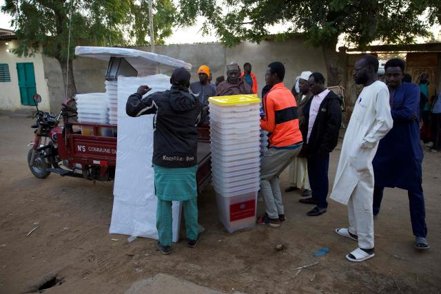 Electoral material is offloaded outside a polling station in N'Djamena on December 29, 2024 at the beginnning of the local, provincial and legislative elections. Chad goes to the polls Sunday for legislative, provincial and local elections that are presented by the government as the last stage of a political transition after three years of military rule, but are being boycotted by the opposition. The boycott leaves the field open to candidates aligned with Marshal Mahamat Idriss Itno, who was brought to power by the military in 2021 and then legitimised in a presidential election last May that opposition candidates denounced as fraudulent. (Photo by Joris Bolomey / AFP)