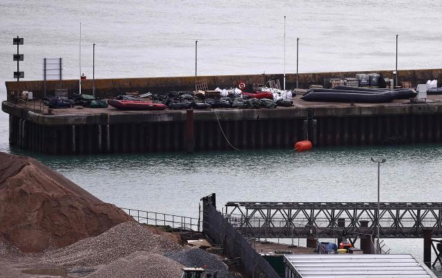 Inflatable dinghies used by migrants on previous attempted crossings of the English Channel from france to England, are pictured stored on the quayside at the harbour at the Port of Dover, on the southeast coast of England on December 30, 2024. (Photo by HENRY NICHOLLS / AFP)