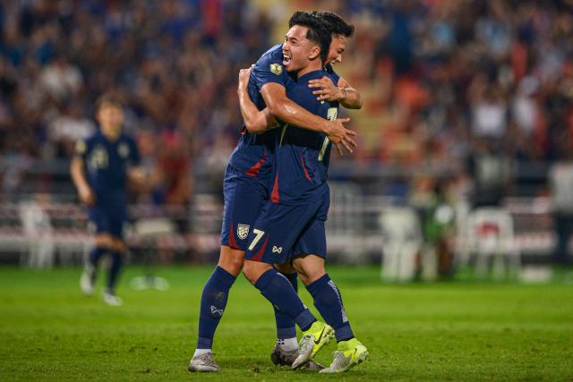 Thailand's forward Patrik Gustavsson (L) celebrates with Thailand's forward Supachok Sarachat (R) after scoring a goal during the 2024 ASEAN Electric Cup semi-final second leg football match between Thailand and the Philippines at the Rajamangala National Stadium in Bangkok on December 30, 2024. (Photo by Amaury PAUL / AFP)