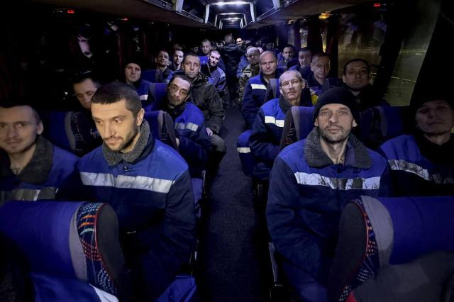 This handout photograph released by the official Telegram channel of Ukrainian President Volodymyr Zelensky on December 30, 2024, shows some of the 189 Ukrainian prisoners of war travelling on a bus, after an exchange at an undisclosed location, amid the Russian invasion in Ukraine. (Photo by HANDOUT / AFP)