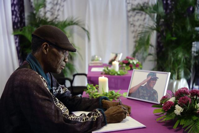 A National Democratic Party (NDP) member and supporter of the late former Surinamese President Desi Bouterse signs the condolence register at the Ocer center in Paramaribo on December 30, 2024. The government of Suriname announced on December 28 that former President Desi Bouterse, who died while on the run from justice, will not receive a state funeral, said Foreign Minister Albert Ramdin. (Photo by Ranu Abhelakh / AFP)