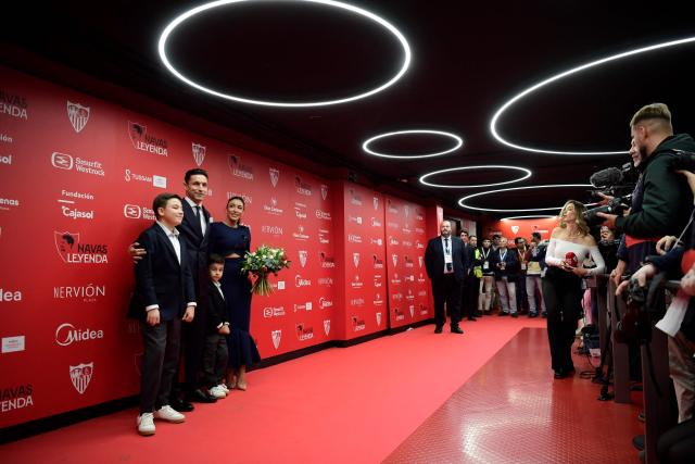 Sevilla's Spanish defender Jesus Navas poses with his wife and children during his farewell ceremony, at the Ramon Sanchez Pizjuan stadium in Sevilla on December 30, 2024. Navas retires after two decades marked by numerous titles with the Sevilla FC and the 2010 FIFA World Cup in South Africa with Spain's national team. (Photo by CRISTINA QUICLER / AFP)