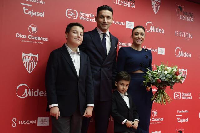 Sevilla's Spanish defender Jesus Navas poses with his wife and children during his farewell ceremony, at the Ramon Sanchez Pizjuan stadium in Sevilla on December 30, 2024. Navas retires after two decades marked by numerous titles with the Sevilla FC and the 2010 FIFA World Cup in South Africa with Spain's national team. (Photo by CRISTINA QUICLER / AFP)