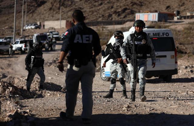 Members of the National Guard stand guard at the crime scene where a National Migration Institute (INM) agent was murdered on a hill near the Precos military checkpoint in the town of Samalayuca, municipality of Juarez, Chihuahua state, Mexico on December 30, 2024. A Mexican immigration agent was murdered on Monday in the northern U.S. border city of Ciudad Juarez as he was asking a group of migrants to identify themselves, according to authorities, who have already arrested three suspects in the crime. (Photo by HERIKA MARTINEZ / AFP)