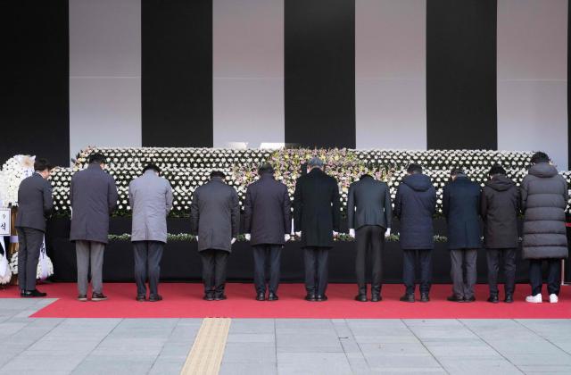 People pay their respects at the altar in front of Seoul City Hall in memory of the victims of the Jeju Air plane crash, in Seoul on December 31, 2024. The Boeing 737-800 was carrying 181 people from Thailand to South Korea when it crashed on arrival on December 29, killing everyone aboard -- save two flight attendants pulled from the twisted wreckage of the worst aviation disaster on South Korean soil. (Photo by Roland DE COURSON / AFP)