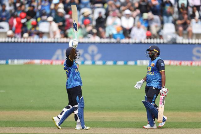 Sri Lanka's Kusal Perera (L) celebrates 100 runs with teammate Bhanuka Rajapaksa during the third Twenty20 cricket match between New Zealand and Sri Lanka at Saxton Oval in Nelson on January 2, 2025. (Photo by Marty MELVILLE / AFP)