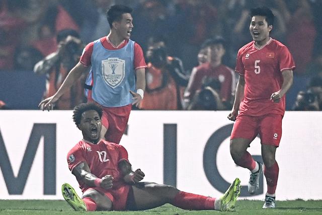 Vietnam's forward Rafaelson celebrates with teammates after scoring a goal during the 2024 ASEAN Electric Cup final first leg football match between Vietnam and Thailand at the Viet Tri Stadium in Phu Tho province on January 2, 2025. (Photo by NHAC NGUYEN / AFP)