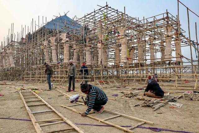 Labourers build a replica of the Ayodhya Ram temple, ahead of the Maha Kumbh Mela festival in Prayagraj on January 2, 2025. (Photo by Niharika KULKARNI / AFP)