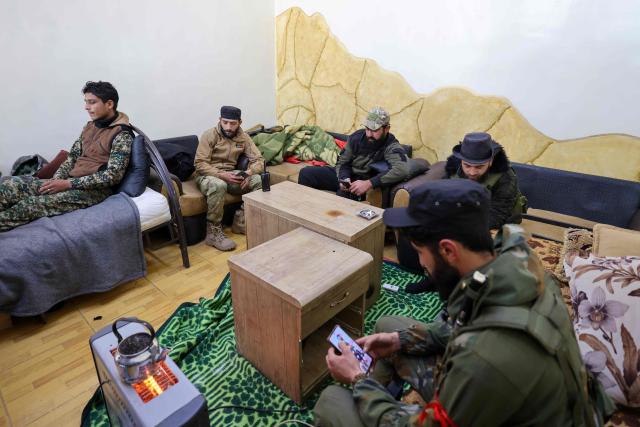 Fighters affiliated with Syria's new administration rest inside the defunct Mezzeh military prison in Damascus on January 2, 2025. (Photo by ANWAR AMRO / AFP)