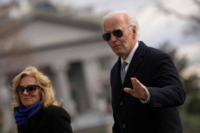 US President Joe Biden and First Lady Jill Biden walk on the South Lawn of the White House as they return to Washington, DC, from Camp David, on January 2, 2025. (Photo by Chris Kleponis / AFP)