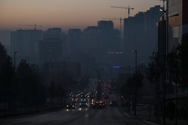 This photograph shows cars in the thick smog of air pollution in Pristina, on January 2, 2025. (Photo by Armend NIMANI / AFP)