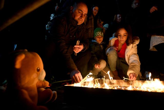 Local residents light candles during national days of mourning in Podgorica on January 2, 2025, after a gunman killed 12 people including two children in a shooting rampage that started in a restaurant. Montenegro began on January 2, 2025 three days of national mourning, a day after a gunman killed 12 people including two children. The 45-year-old attacker died after shooting himself in the head when he was surrounded following an hours-long manhunt, police said. (Photo by SAVO PRELEVIC / AFP)