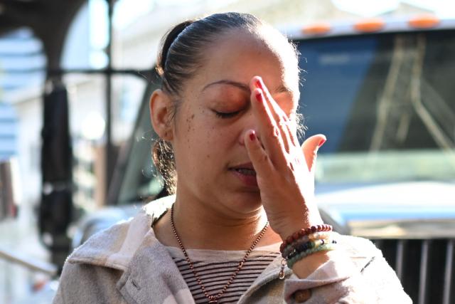 Samantha Rae Petry reacts after arranging a memorial of flowers on Bourbon Street after it reopened to the public on January 2, 2025 in New Orleans, Louisiana, following a terrorist attack on January 1. At least 15 people were killed and 30 injured on January 1 when a vehicle plowed overnight into a New Year's crowd in the heart of the thriving New Orleans tourist district, authorities in the southern US city said. (Photo by ANDREW CABALLERO-REYNOLDS / AFP)