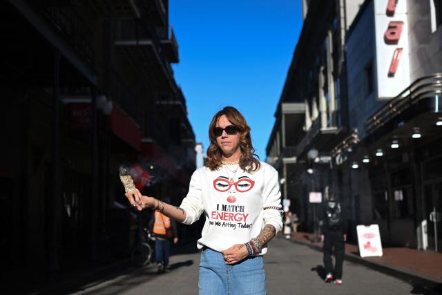 Stephanie Drake burns sage to cleanse the area on  Bourbon Street after it reopened to the public on January 2, 2025 in New Orleans, Louisiana, following a terrorist attack on January 1. At least 15 people were killed and 30 injured on January 1 when a vehicle plowed overnight into a New Year's crowd in the heart of the thriving New Orleans tourist district, authorities in the southern US city said. (Photo by ANDREW CABALLERO-REYNOLDS / AFP)