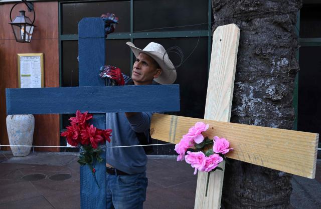 Eduardo Marquez paints crosses set up as a memorial near Bourbon Street on January 2, 2025 in New Orleans, Louisiana, the day after an attack by a man driving a truck down Bourbon street in the French Quarter. At least 15 people were killed and 30 injured on January 1 when a vehicle plowed overnight into a New Year's crowd in the heart of the thriving New Orleans tourist district, authorities in the southern US city said. (Photo by ANDREW CABALLERO-REYNOLDS / AFP)