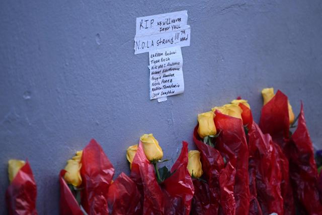 A sign is seen near flowers set up as a memorial on Bourbon Street on January 2, 2025 in New Orleans, Louisiana, the day after an attack by a man driving a truck down Bourbon street in the French Quarter. At least 15 people were killed and 30 injured on January 1 when a vehicle plowed overnight into a New Year's crowd in the heart of the thriving New Orleans tourist district, authorities in the southern US city said. (Photo by ANDREW CABALLERO-REYNOLDS / AFP)