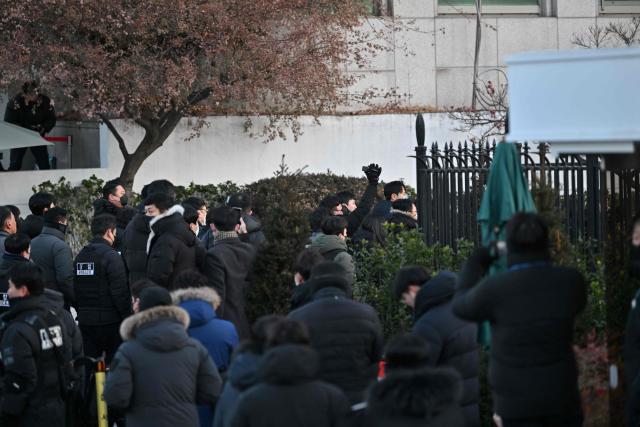 Police and anti-corruption investigators arrive at the residence of South Korea's impeached President Yoon Suk Yeol in Seoul on January 3, 2025. South Korean investigators arrived outside the presidential residence early Friday seeking to arrest Yoon Suk Yeol, with the impeached leader's die-hard supporters massing outside to protect him, AFP reporters saw. Cars carrying investigators probing Yoon's short-lived declaration of martial law drove up to his residence in central Seoul, which was surrounded by a heavy police presence, AFP saw. Yoon would become the first sitting president in South Korean history to be arrested. (Photo by JUNG Yeon-je / AFP)