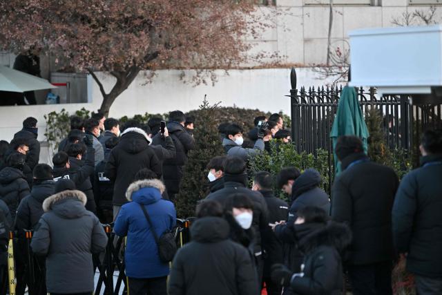 Police and anti-corruption investigators arrive at the residence of South Korea's impeached President Yoon Suk Yeol in Seoul on January 3, 2025. South Korean investigators arrived outside the presidential residence early Friday seeking to arrest Yoon Suk Yeol, with the impeached leader's die-hard supporters massing outside to protect him, AFP reporters saw. Cars carrying investigators probing Yoon's short-lived declaration of martial law drove up to his residence in central Seoul, which was surrounded by a heavy police presence, AFP saw. Yoon would become the first sitting president in South Korean history to be arrested. (Photo by JUNG Yeon-je / AFP)