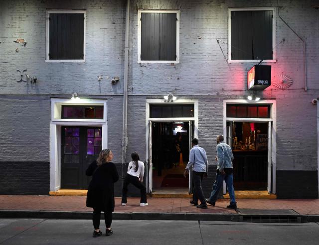 The French Quarter, near Bourbon Street, is blocked off on January 2, 2025 in New Orleans, Louisiana, following a terrorist attack on January 1. Two women dance in front of a bar on Bourbon Street after it reopened on January 2, 2025 in New Orleans, Louisiana, the day after an attack by a man driving a truck down Bourbon street in the French Quarter. (Photo by ANDREW CABALLERO-REYNOLDS / AFP)