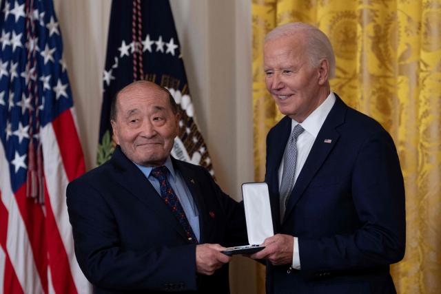 Wayne Tsutsumi receives the Presidential Citizens Medal on behalf of Mitsuye Endo Tsutsumi from US President Joe Biden during a ceremony at the White House in Washington, DC, on January 2, 2025. (Photo by Chris Kleponis / AFP)