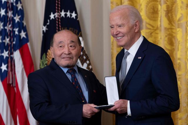 Wayne Tsutsumi receives the Presidential Citizens Medal on behalf of Mitsuye Endo Tsutsumi from US President Joe Biden during a ceremony at the White House in Washington, DC, on January 2, 2025. (Photo by Chris Kleponis / AFP)