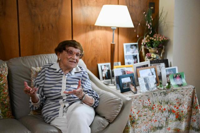 Holocaust survivor Lea Zajac de Novera, 98, gestures as she speaks during an interview with AFP in Buenos Aires on January 2, 2025. Zajac de Novera was born in Michalowo, a town in the province of Bialystok, Poland, on December 31, 1926. At the beginning of the war, she lived with her family under Soviet occupation until 1942, when she and her family were relocated to the Pruzhany ghetto. In 1943 she was deported to the Auschwitz-Birkenau concentration camp, where she worked collecting rubble and sorting clothes of those killed in the gas chambers. (Photo by LUIS ROBAYO / AFP)