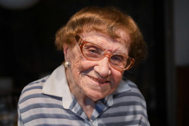 Holocaust survivor Lea Zajac de Novera, 98, looks on as she poses for a picture during an interview with AFP in Buenos Aires on January 2, 2025. Zajac de Novera was born in Michalowo, a town in the province of Bialystok, Poland, on December 31, 1926. At the beginning of the war, she lived with her family under Soviet occupation until 1942, when she and her family were relocated to the Pruzhany ghetto. In 1943 she was deported to the Auschwitz-Birkenau concentration camp, where she worked collecting rubble and sorting clothes of those killed in the gas chambers. (Photo by LUIS ROBAYO / AFP)