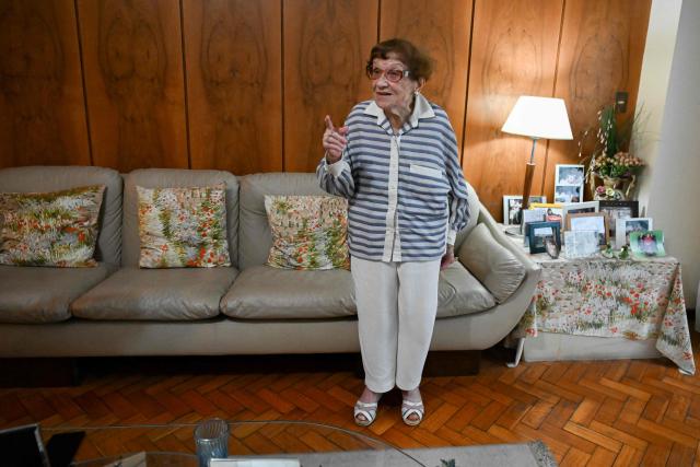 Holocaust survivor Lea Zajac de Novera, 98, gestures as she speaks during an interview with AFP in Buenos Aires on January 2, 2025. Zajac de Novera was born in Michalowo, a town in the province of Bialystok, Poland, on December 31, 1926. At the beginning of the war, she lived with her family under Soviet occupation until 1942, when she and her family were relocated to the Pruzhany ghetto. In 1943 she was deported to the Auschwitz-Birkenau concentration camp, where she worked collecting rubble and sorting clothes of those killed in the gas chambers. (Photo by LUIS ROBAYO / AFP)