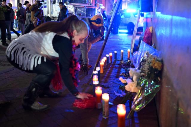 People pay their respects at a memorial set up on Bourbon Street on January 2, 2025 in New Orleans, Louisiana, the day after an attack by a man driving a truck down Bourbon street in the French Quarter. A US army veteran loyal to the Islamic State jihadist group likely acted alone when he killed 14 and injured dozens in a truck attack on a crowd of New Year revelers in New Orleans, the FBI said Thursday. Despite initial concerns that Shamsud-Din Jabbar, 42, had accomplices still on the run, preliminary investigations show he likely acted alone, FBI deputy assistant director Christopher Raia said. (Photo by ANDREW CABALLERO-REYNOLDS / AFP)